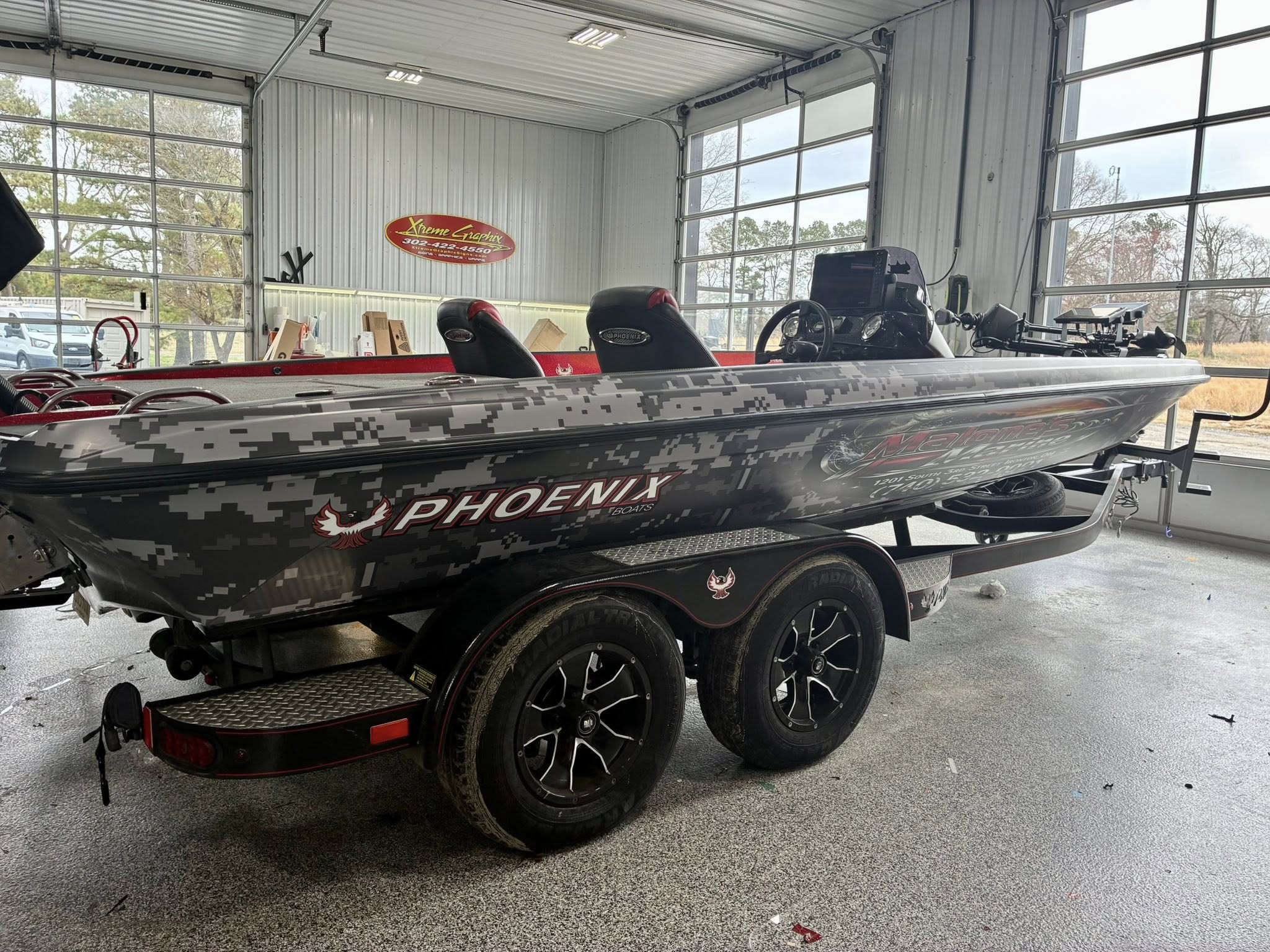 Phoenix bass boat with custom digital camo wrap by Xtreme Graphix